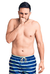 Fototapeta premium Young handsome man wearing swimwear feeling unwell and coughing as symptom for cold or bronchitis. health care concept.