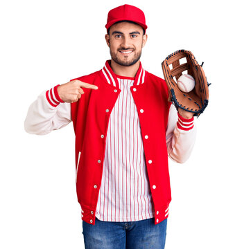 Young handsome man holding baseball gloves pointing finger to one self smiling happy and proud