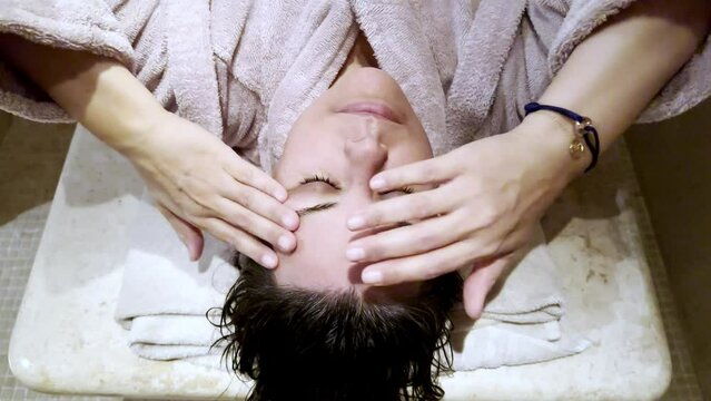 Directly Above on a Woman Face with Eyes Closed who Relax in a Turkish Hammam Bathroom in Switzerland.
