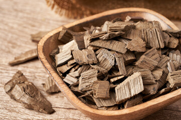 close up french oak wood chip for smoking meat and fish in wooden bowl on food table background