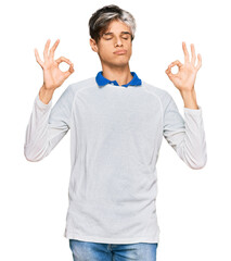 Young hispanic man wearing casual clothes relax and smiling with eyes closed doing meditation gesture with fingers. yoga concept.