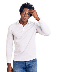 Handsome african american man with afro hair wearing casual clothes and glasses worried and...