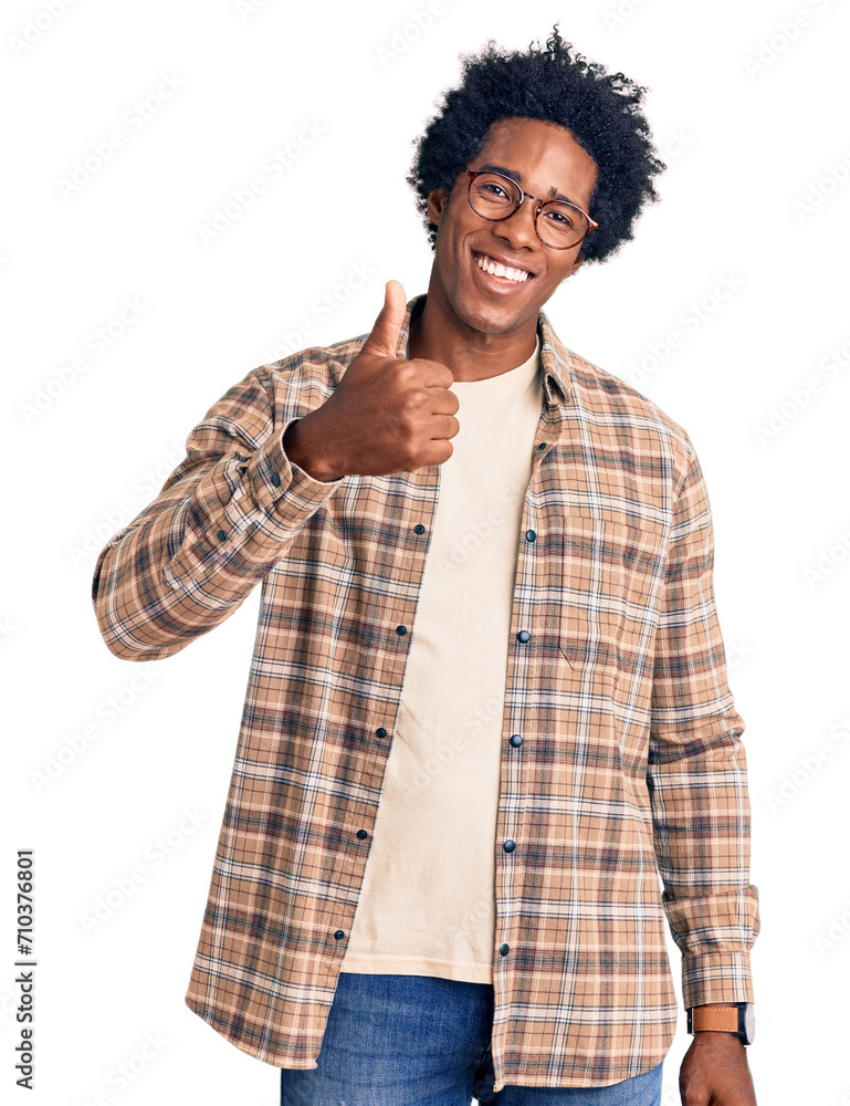 Wall mural handsome african american man with afro hair wearing casual clothes and glasses doing happy thumbs u