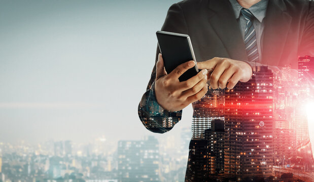 Double Exposure Image of Business Communication Network Technology Concept - Business people using smartphone or mobile phone device on modern cityscape background. uds