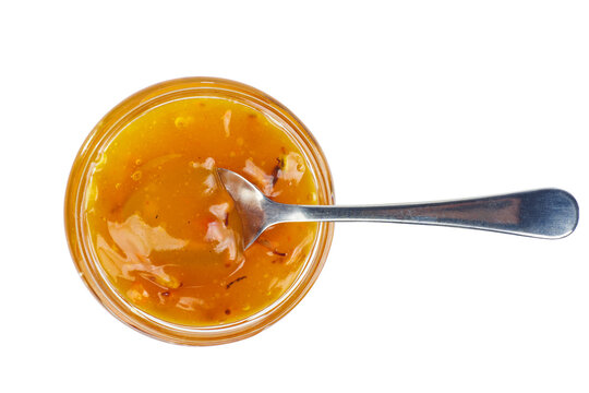 Seabuckthorn jam in glass jare with spoon isolated on a white background