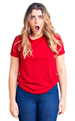 Fototapeta premium Young caucasian woman wearing casual clothes afraid and shocked with surprise expression, fear and excited face.