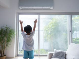 A boy under air conditioner feeling relax at home