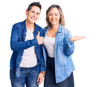Couple of women wearing casual clothes showing palm hand and doing ok gesture with thumbs up, smiling happy and cheerful - Powered by Adobe