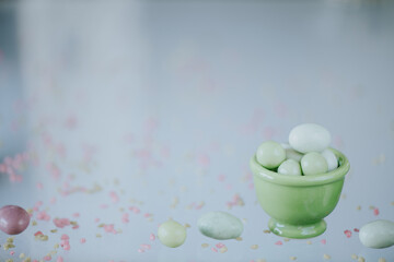 Easter background with colored sugar eggs and copy space