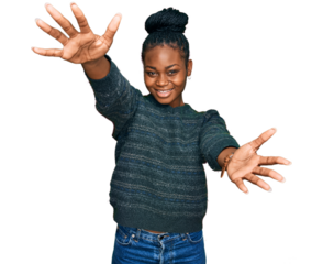 Young african american woman wearing casual clothes looking at the camera smiling with open arms for hug. cheerful expression embracing happiness.