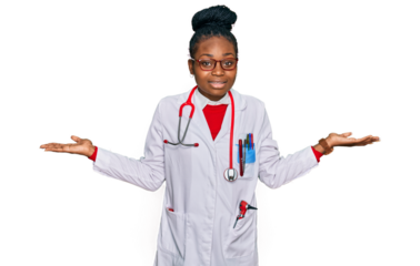 Young african american woman wearing doctor uniform and stethoscope smiling showing both hands open palms, presenting and advertising comparison and balance