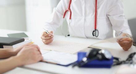 Doctor takes care of patient and makes entries in medical record. Medical services therapist concept