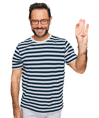 Middle age man wearing casual clothes and glasses showing and pointing up with fingers number four while smiling confident and happy.
