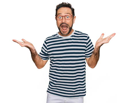 Middle age man wearing casual clothes and glasses celebrating crazy and amazed for success with arms raised and open eyes screaming excited. winner concept