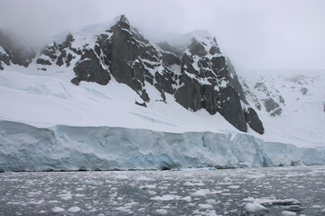 Glacier, icebergs and mountains, Orne Harbour, Antarctica.