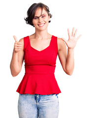 Beautiful young woman with short hair wearing casual style with sleeveless shirt showing and pointing up with fingers number six while smiling confident and happy.