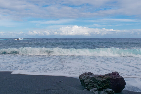 Low-angle view of waves at Pohoiki black sand beach, Isaac Hale Park on the Big Island of Hawaii