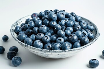 Freshly picked blueberries, isolated on a white ceramic plate background