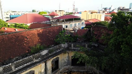 Descending drone footage above the old police station built during french Protectorat in Phnom Penh, Cambodia - Powered by Adobe