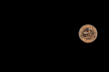 One dollar gold coin. black isolated background.