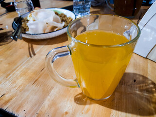 Squeezed orange drink in a glass cup on the table