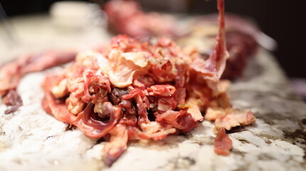Closeup of substandard meat scraps for animal feed production. Deboning of meat concept