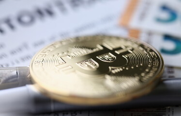 Gold bitcoin lies on table. Making money on bitcoins without investments concept