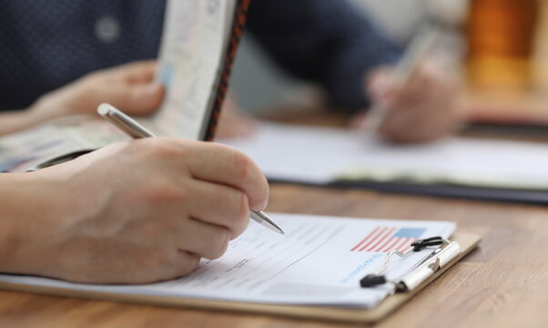 Man filling out documents for US visa closeup. Official travel abroad concept
