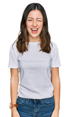 Obraz premium Young beautiful woman wearing casual white t shirt winking looking at the camera with sexy expression, cheerful and happy face.