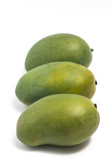 Three fresh organic green mango delicious fruit side view isolated on white background clipping path