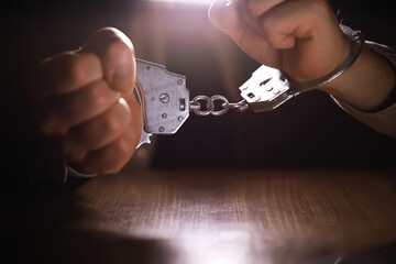 stressed out businessman hands bothered with handcuffs suffering at custody for concept of...