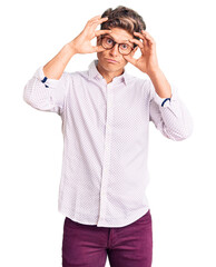 Young handsome man wearing business clothes and glasses trying to open eyes with fingers, sleepy and tired for morning fatigue