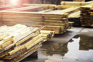 Stack of fresh pine boards in a sawmill warehouse. Harvesting, sale of lumber for construction