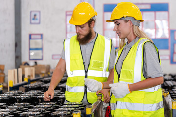 An expert inspectors or supervisor are checking a spare parts or automobile. Professional engineer is checking a merchandise package before shipping or delivery in storehouse or warehouse of factory.