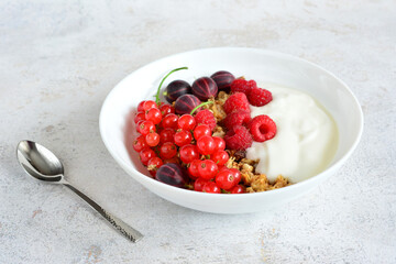 granola with yogurt, red currant, gooseberry and raspberry copy space