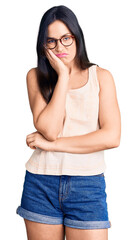 Young beautiful caucasian woman wearing casual clothes and glasses thinking looking tired and bored with depression problems with crossed arms.