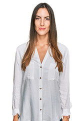 Young beautiful woman wearing casual clothes relaxed with serious expression on face. simple and natural looking at the camera.