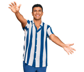 Young arab man wearing casual clothes looking at the camera smiling with open arms for hug. cheerful expression embracing happiness.