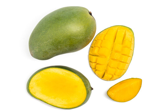 Sliced half cut into cubes and whole fresh organic green mango delicious fruit flat lay isolated on white background clipping path