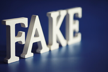 The letters spelled the word fake. The concept of modern information technology. Fake and facts in...