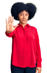 Fototapeta na wymiar Young african american girl wearing casual clothes doing stop sing with palm of the hand. warning expression with negative and serious gesture on the face.