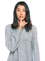 Beautiful asian young woman wearing casual clothes asking to be quiet with finger on lips. silence and secret concept.