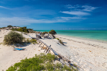 A tradtional boat lakana on the white beach in Mamirano bay, Madagascar