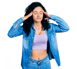 Young hispanic woman with curly hair wearing casual denim shirt with hand on head, headache because stress. suffering migraine.