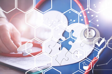 Stethoscope, puzzle heart, prescriptions. Double exposure in composition. Doctor`s desk in the clinic's office.