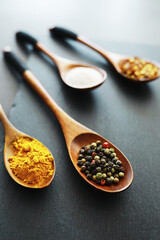 Wooden spoons with spices. A mixture of peppers and spices. Fragrant herbs for food.