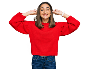 Beautiful brunette woman wearing casual winter sweater smiling pulling ears with fingers, funny gesture. audition problem