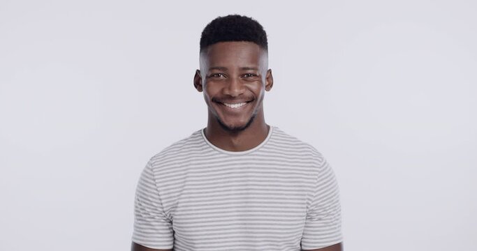 Happy, smile and face of black man on a white background with confidence, cheerful expression and joy. Emoji, isolated and portrait of African person with pride, excited and casual style in studio