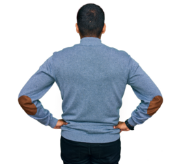 Young handsome hispanic man wearing casual sweatshirt standing backwards looking away with arms on body