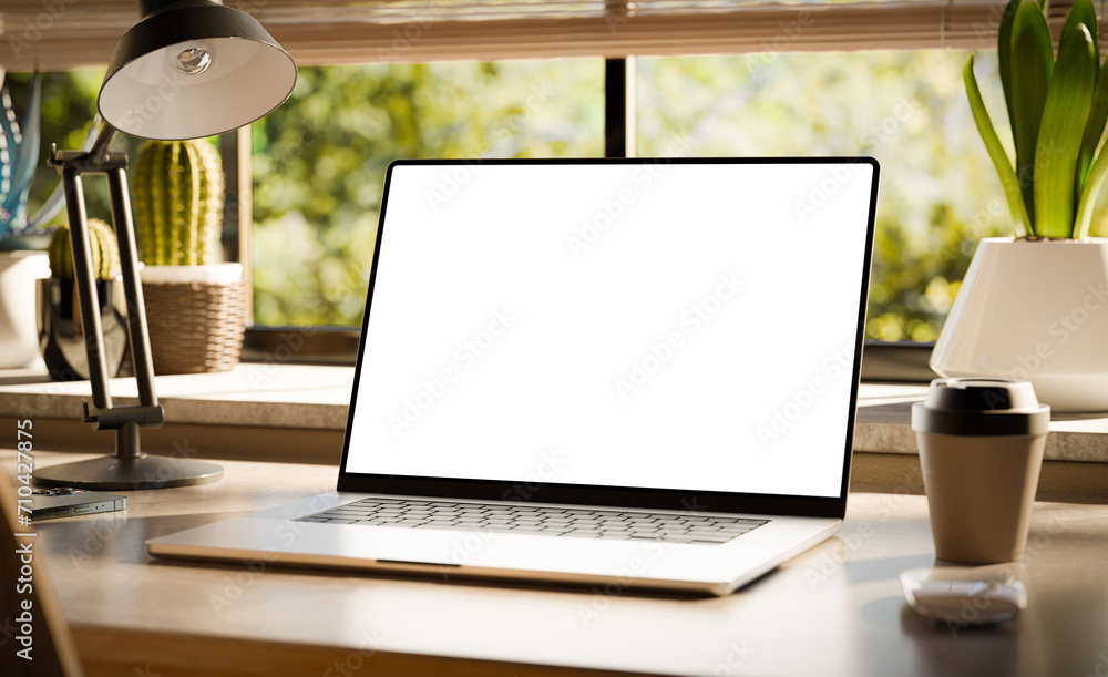Aufkleber a laptop with a blank screen sits on a stylish wooden desk within a loft-style interior, with green 
